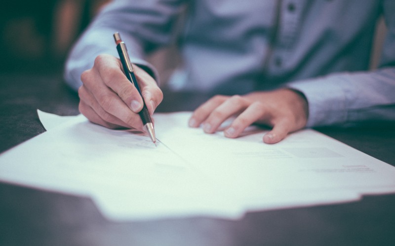 Signing paper. Credit: Scott Graham, Unsplash